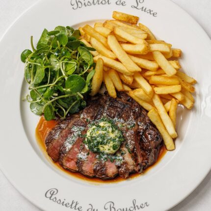 Classic French steak frites served with garlic butter at Galvin Bistrot and Bar London.