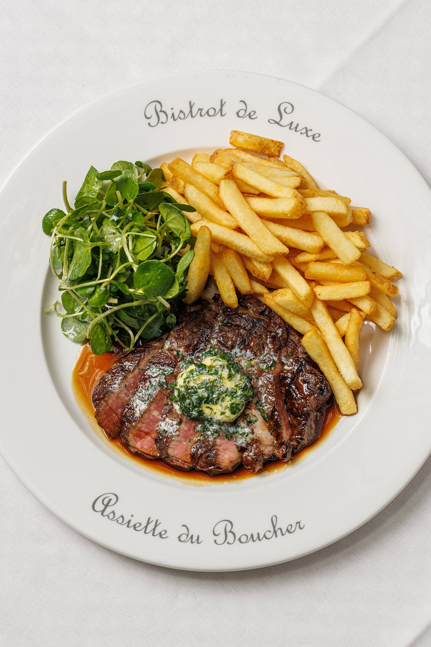 Classic French steak frites served with garlic butter at Galvin Bistrot and Bar London.