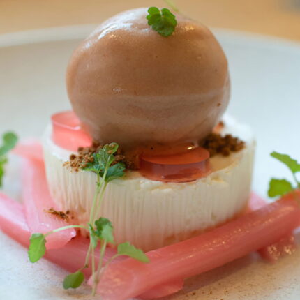 A beautifully presented modern British main course featuring vibrant, seasonal ingredients sourced from local Essex farms.