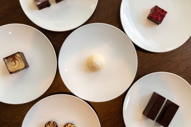 Artistically plated white chocolate and passion fruit sphere at Galvin London.