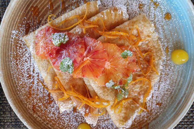 Beautifully plated Shrove Tuesday pancakes topped with fresh seasonal berries.
