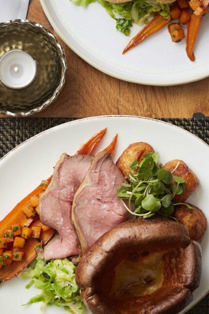 A succulent, perfectly pink roast sirloin of beef served with a golden Yorkshire pudding for a traditional Sunday lunch.
