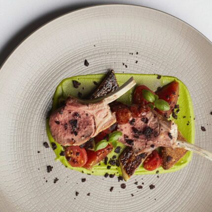An elegantly plated spring lamb rump accompanied by a vibrant wild garlic purée.