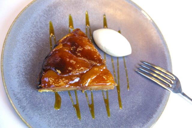 The famous Galvin Apple Tarte Tatin, perfectly caramelized and flipped onto a plate.