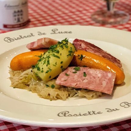 Gourmet French Oktoberfest dishes featuring smoked sausages, pork, and sauerkraut at Galvin.