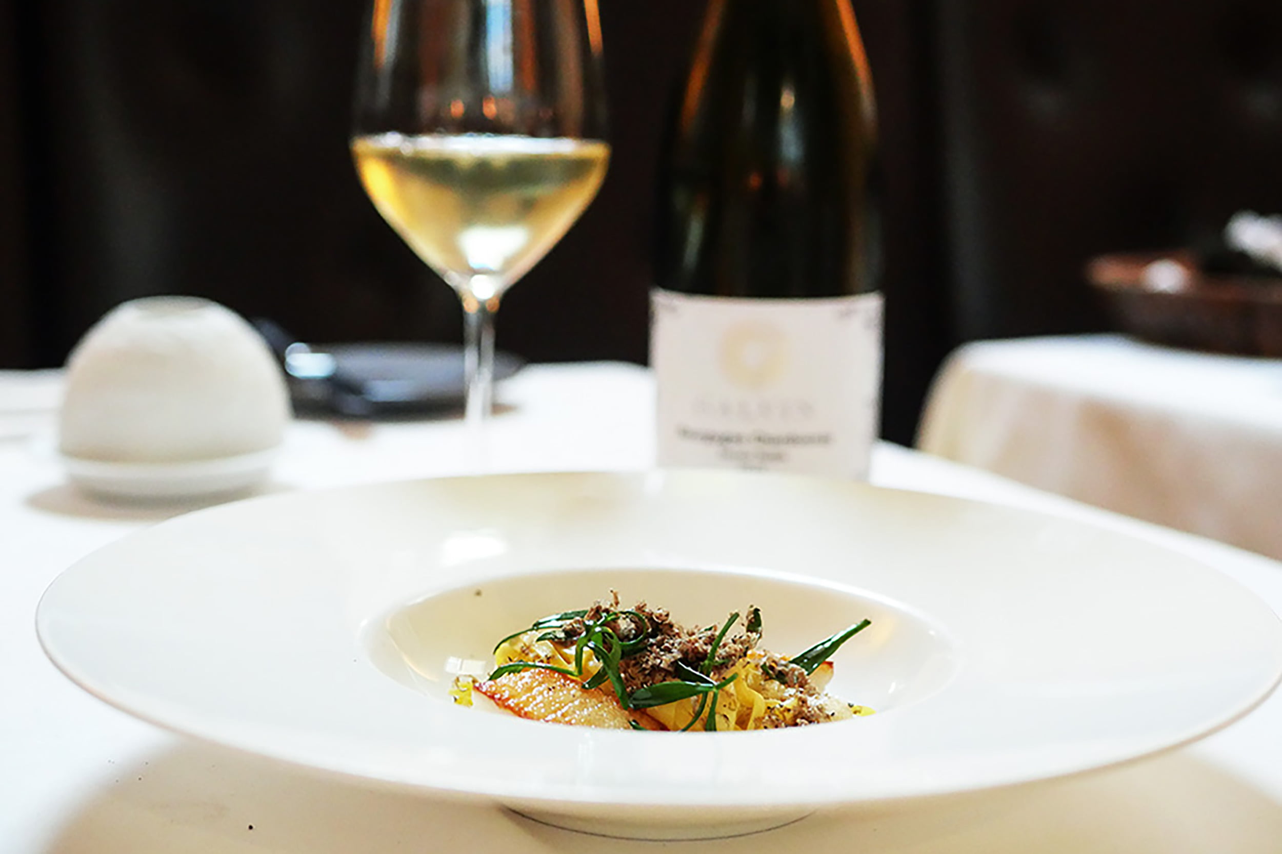 Finely shaved black truffle over a modern French culinary creation at Galvin La Chapelle
