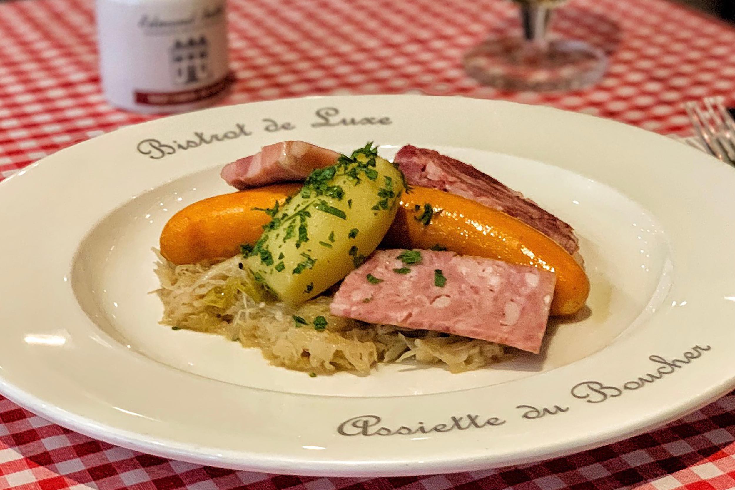 Gourmet French Oktoberfest dishes featuring smoked sausages, pork, and sauerkraut at Galvin.