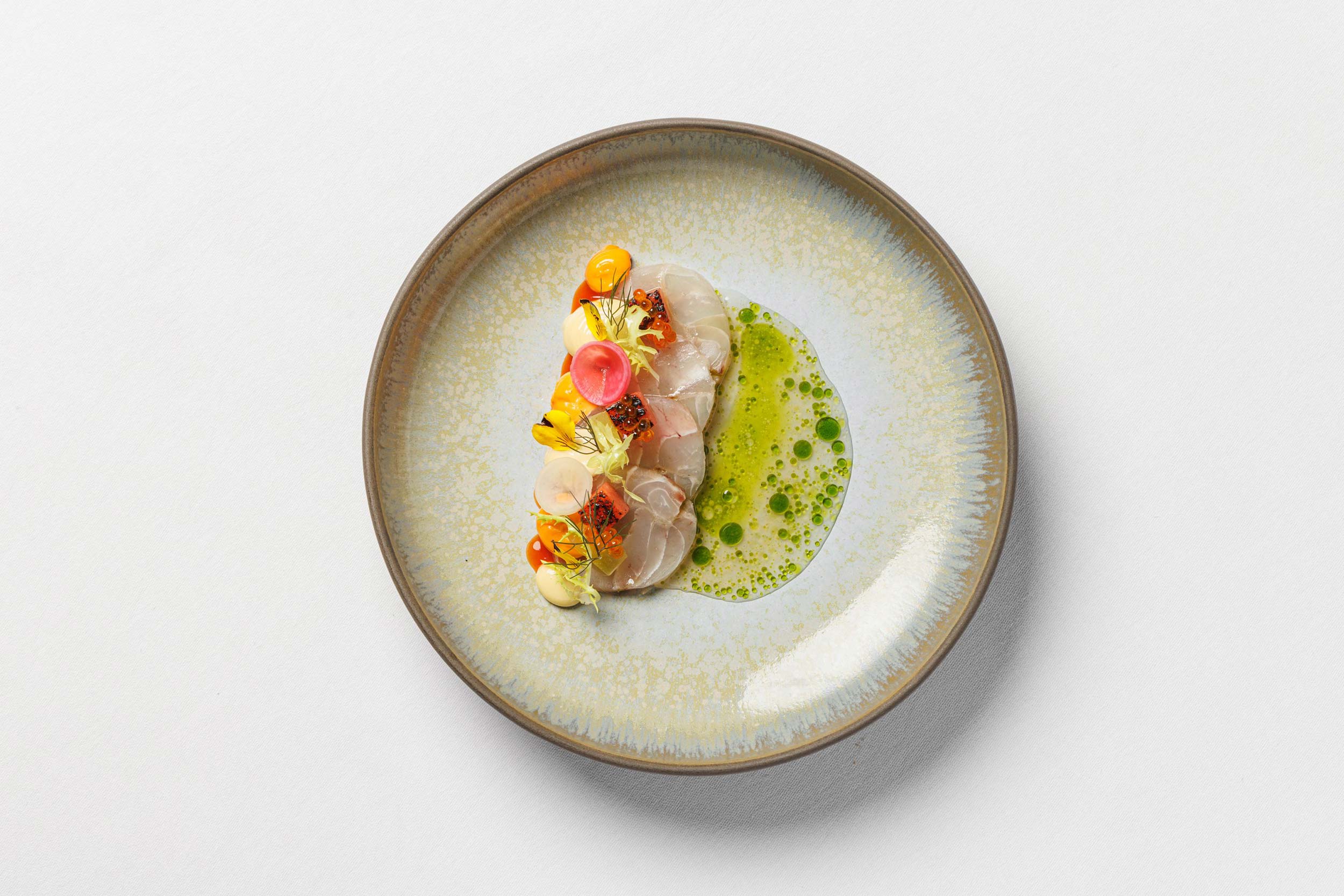 Artistically plated fine dining course paired with South African wine at Galvin's.