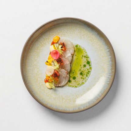 An artistically plated fine dining course elegantly paired with a premium South African vintage.