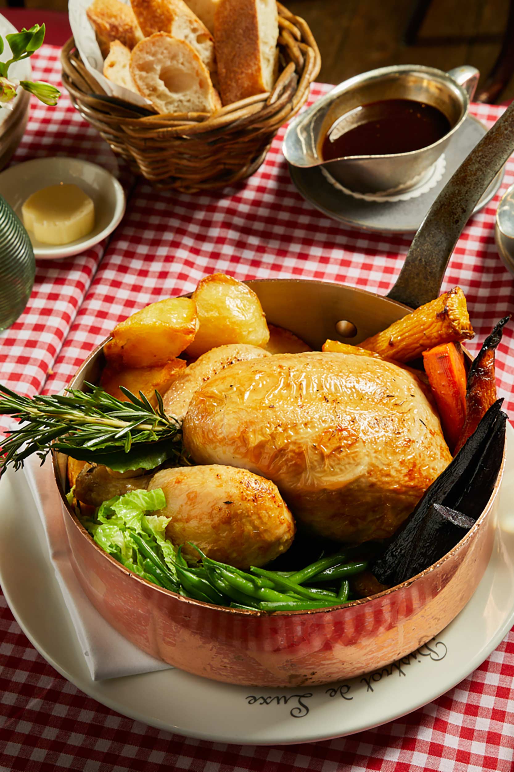 Slow-cooked roast corn-fed chicken served with rich gravy at Galvin La Chapelle London.