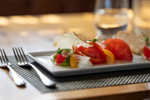 Elegant, sunlit table setting curated for a luxury summer lunch experience.