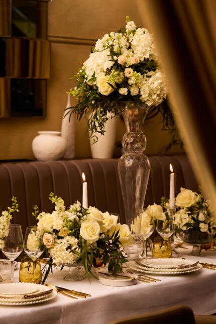 Intimate candlelight casting a romantic glow over the Galvin wedding table settings.