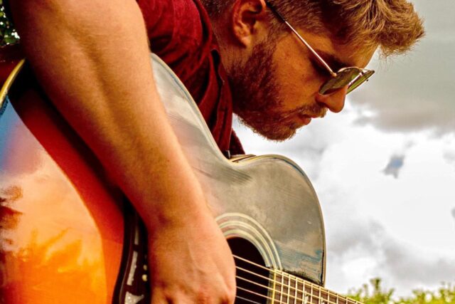 Singer-songwriter Sam performing a live acoustic set at Galvin Green Man near Witham