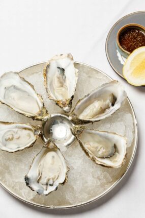Freshly shucked oysters served with lemon at Galvin Bistrot & Bar Oyster Hour.