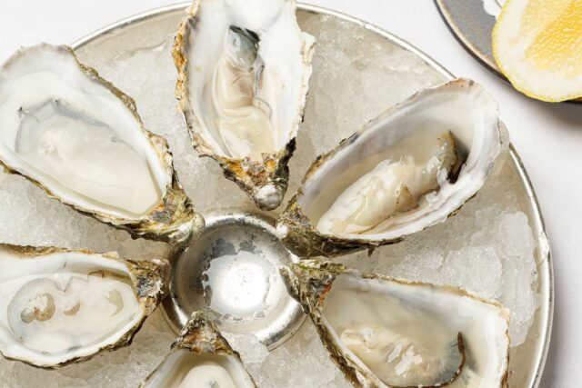 Freshly shucked oysters served with lemon at Galvin Bistrot & Bar Oyster Hour.