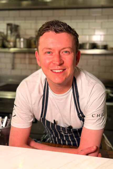 Chef Director Arturo Granato standing proudly within the bustling kitchen of our Michelin-starred Spitalfields restaurant.