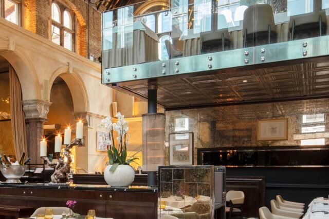 Grand arched hall dining room setup for the annual Grouse Dinner at Galvin La Chapelle.